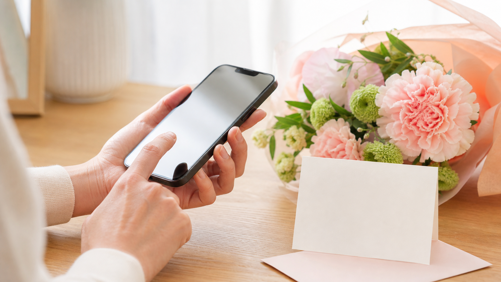 母の日に遅れてごめんねとスマホでメッセージを送るイメージ